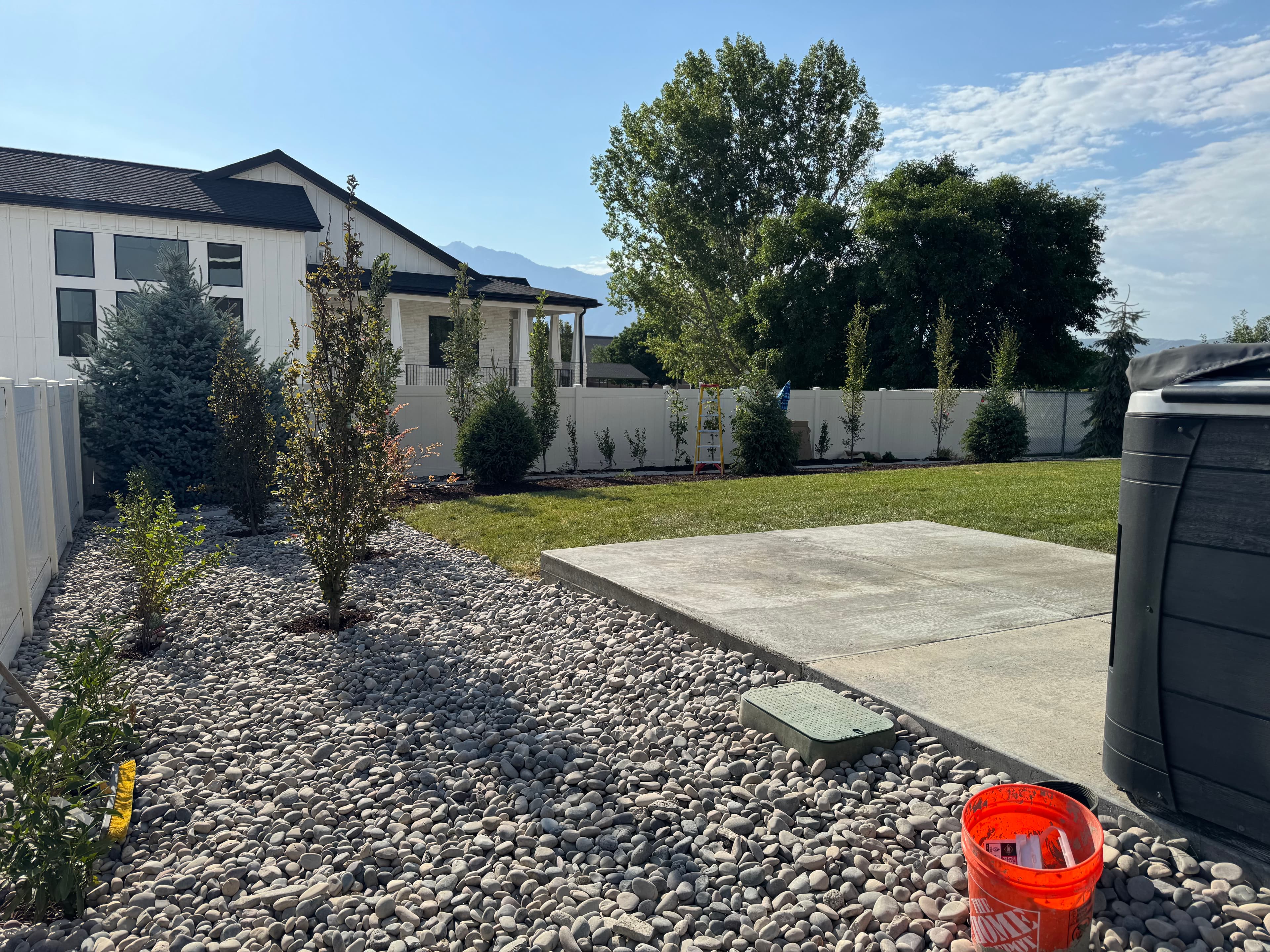 Project Backyard Patio Expansion with River Rock and Garden Beds image