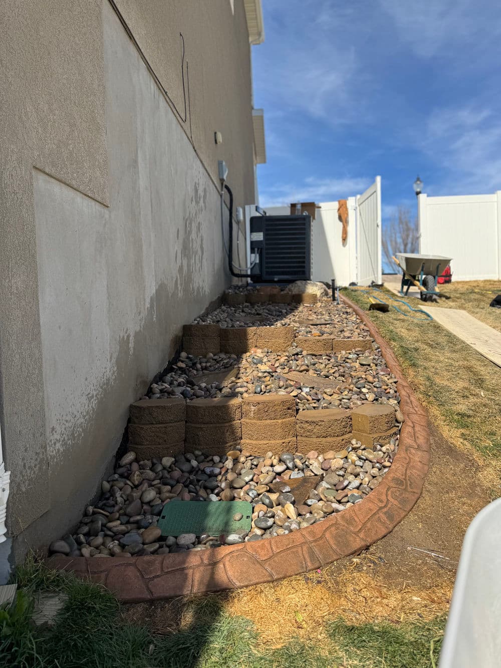 Gallery photos for Steep Grade Garden Bed Gets Retaining Wall Tiers and River Rock: Image #4