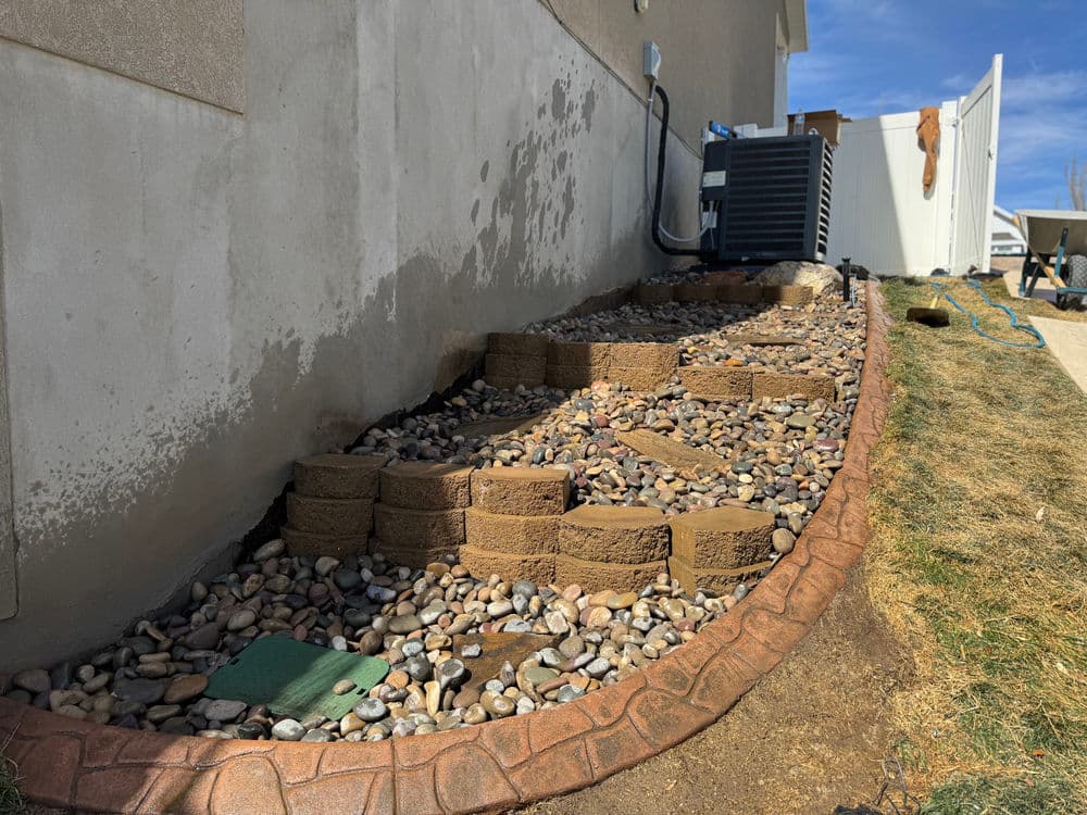 Steep Grade Garden Bed Gets Retaining Wall Tiers and River Rock image