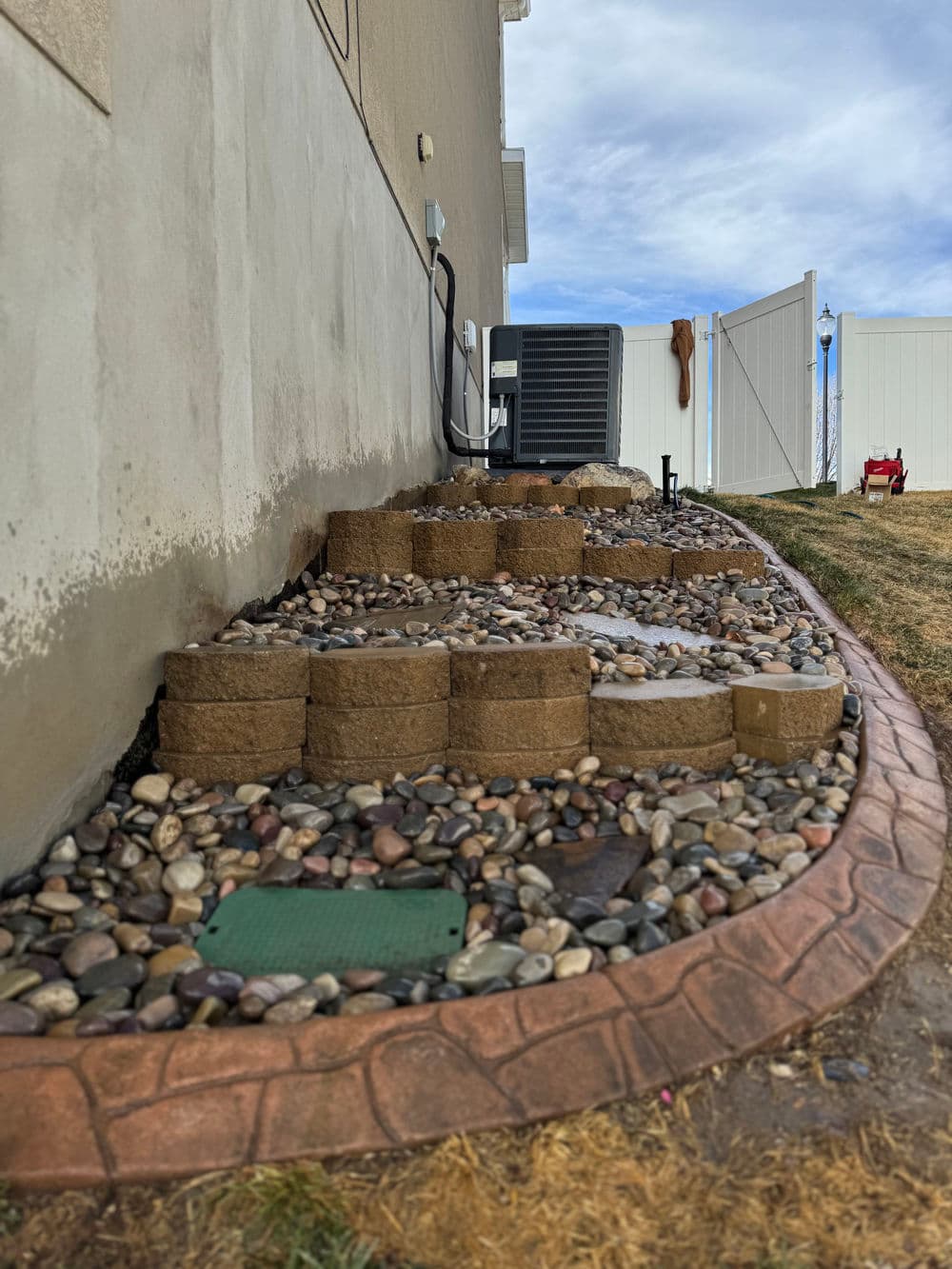 Gallery photos for Steep Grade Garden Bed Gets Retaining Wall Tiers and River Rock: Image #9