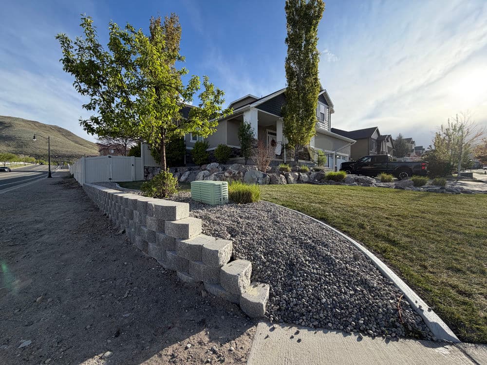 River Rock Xeriscaping with Concrete Curbing and Retaining Wall in Herriman image