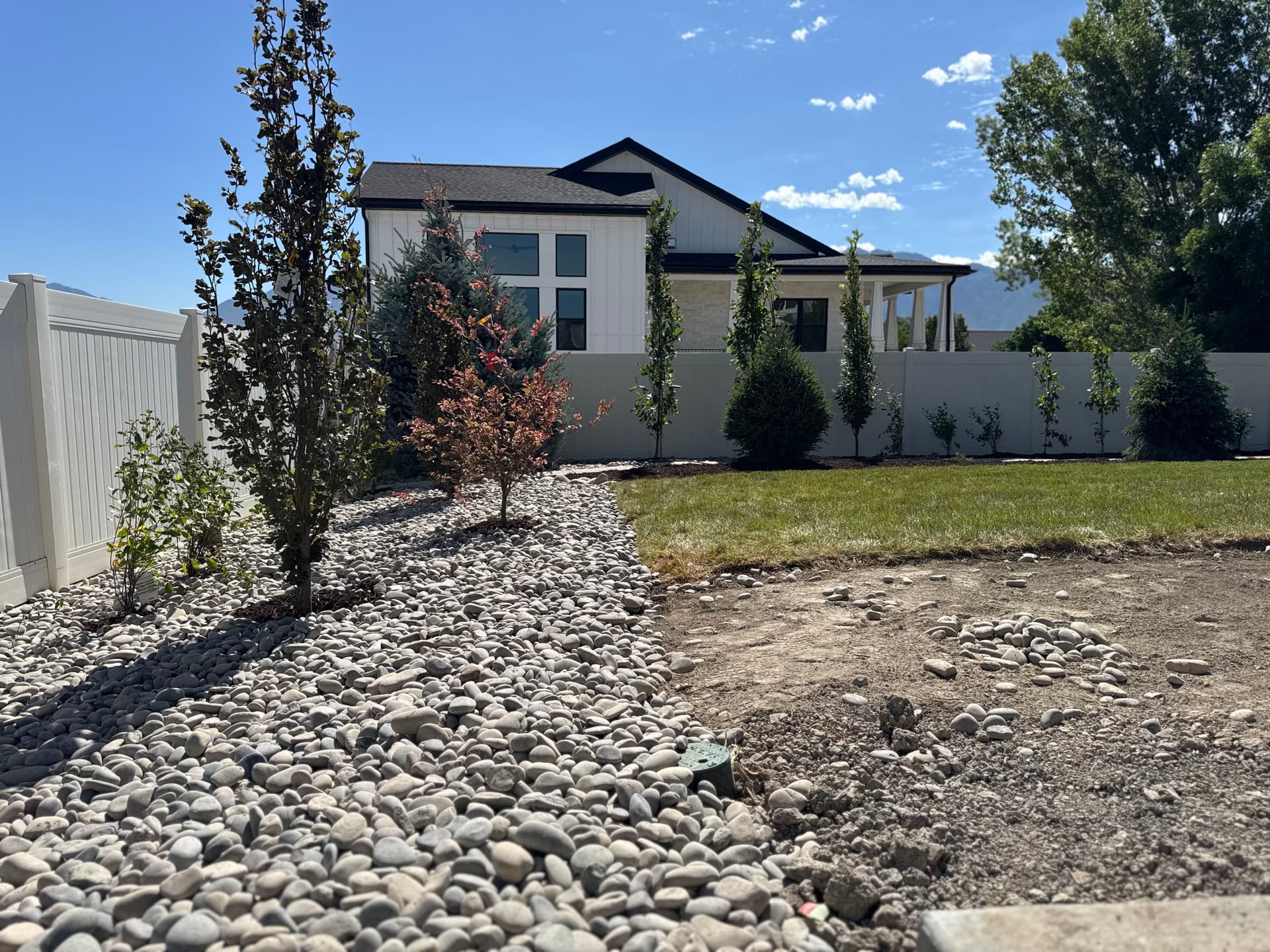 Gallery photos for Backyard Patio Expansion with River Rock and Garden Beds: Image #7